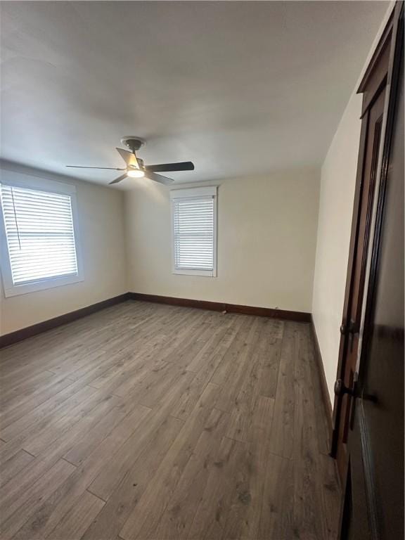 spare room featuring ceiling fan and light wood-type flooring