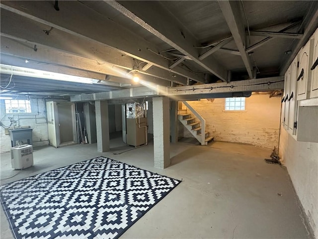 basement with heating unit and a healthy amount of sunlight