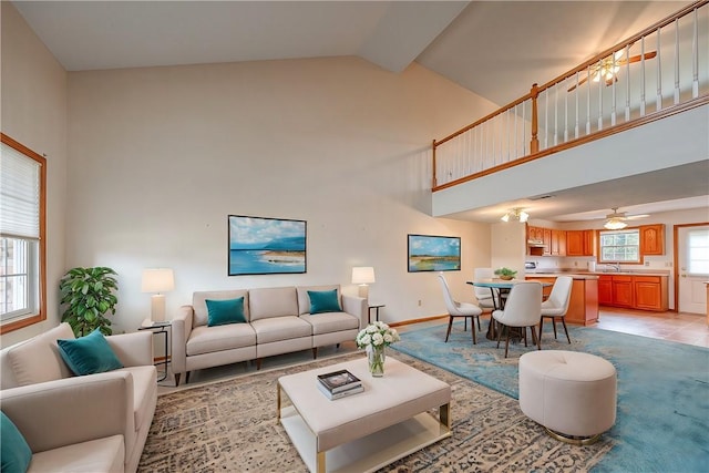 living room featuring sink and high vaulted ceiling