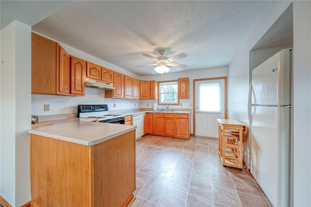 kitchen featuring sink, white appliances, ceiling fan, kitchen peninsula, and a textured ceiling