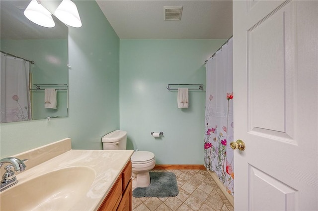 bathroom featuring vanity, toilet, and curtained shower