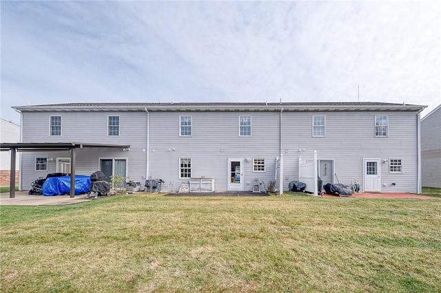 rear view of house with a yard and a patio