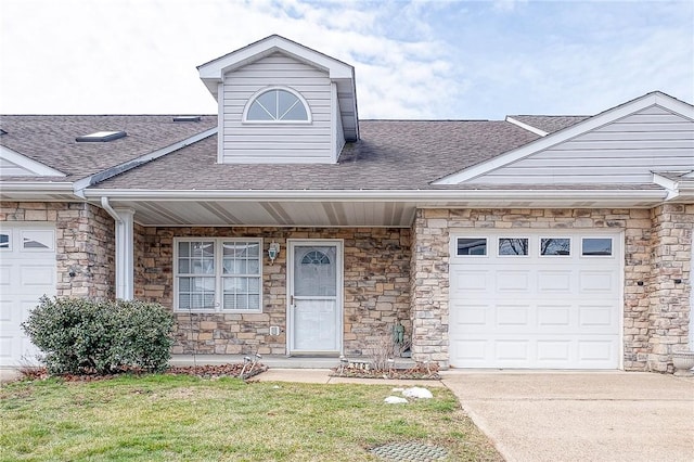 view of front facade with a garage and a front lawn