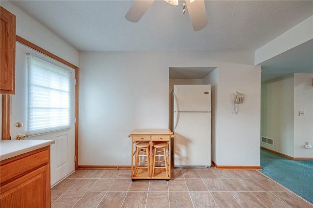 interior space featuring white refrigerator and ceiling fan