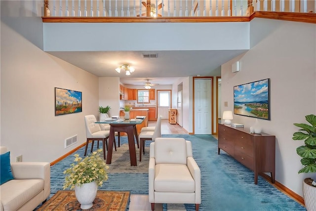 living room with ceiling fan and carpet