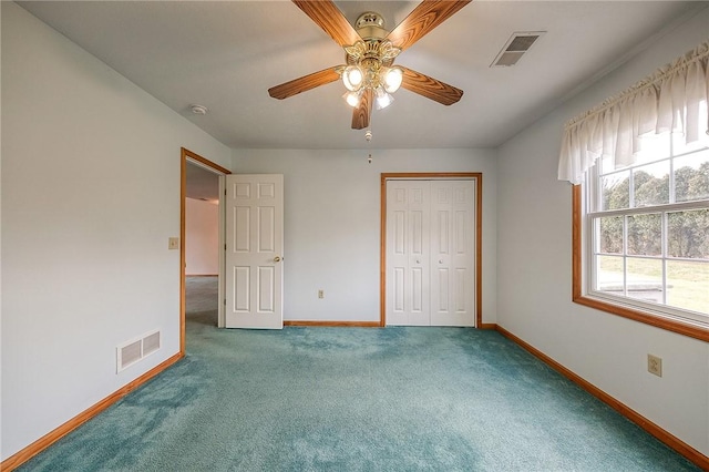 unfurnished bedroom with carpet flooring, ceiling fan, and a closet