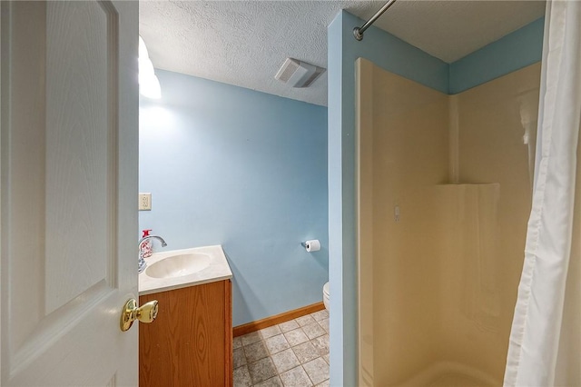 bathroom with vanity, toilet, a textured ceiling, and a shower with shower curtain