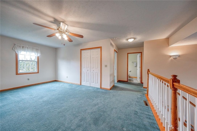 interior space featuring ceiling fan and a textured ceiling