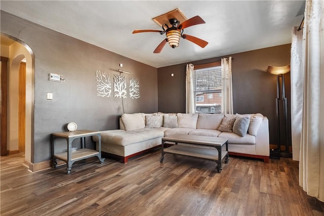 living room featuring dark hardwood / wood-style floors and ceiling fan