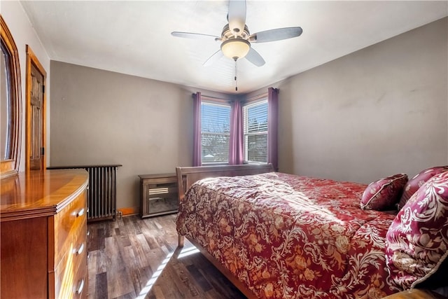 bedroom featuring ceiling fan, dark hardwood / wood-style flooring, and radiator