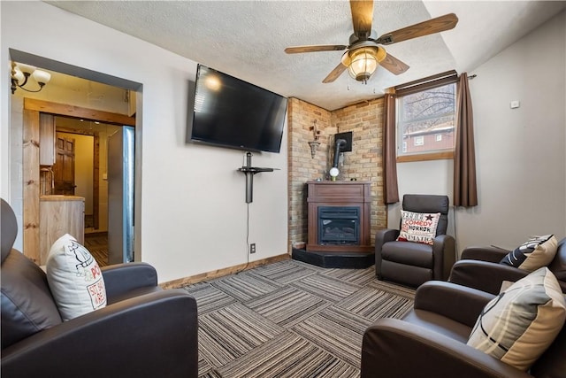 carpeted living room featuring ceiling fan and a textured ceiling