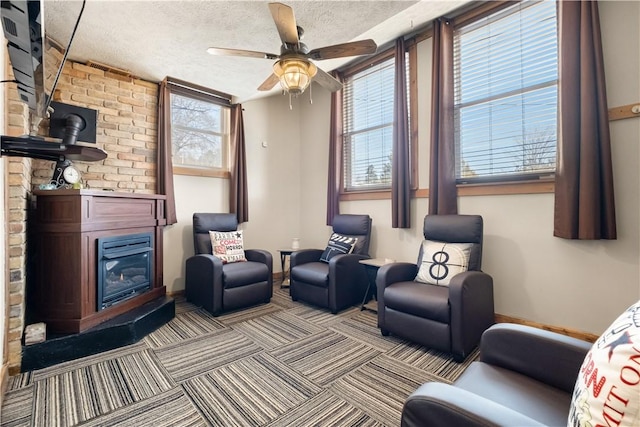 interior space with ceiling fan, a wealth of natural light, and a textured ceiling