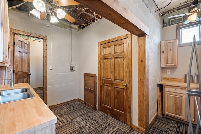 interior space featuring ceiling fan and sink