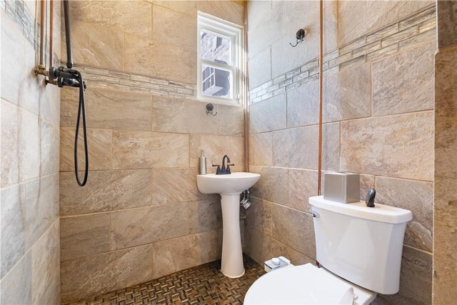 bathroom with tile walls and toilet