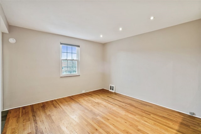 spare room featuring wood-type flooring