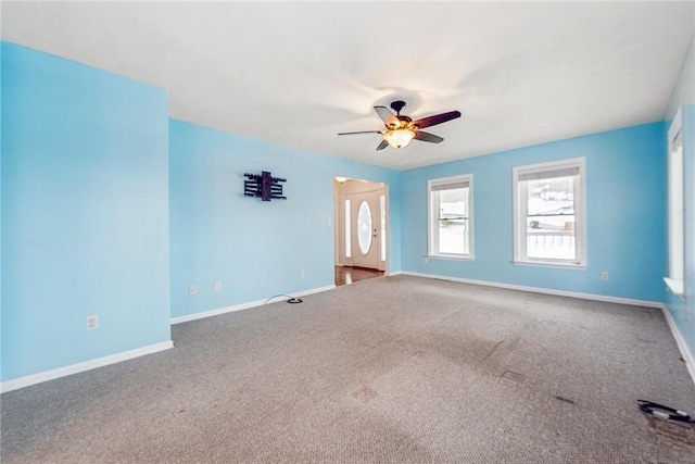 empty room featuring carpet floors and ceiling fan