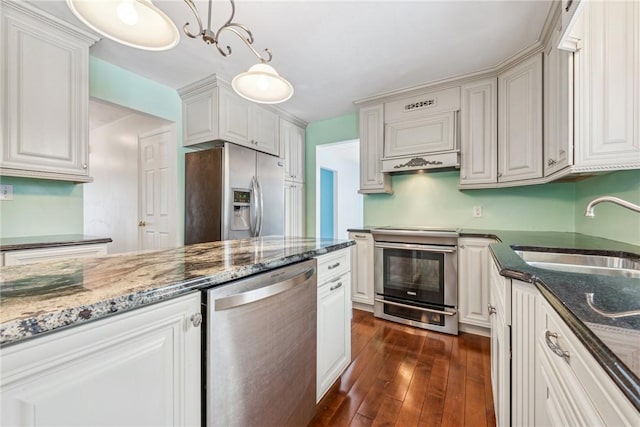 kitchen with white cabinetry, hanging light fixtures, and stainless steel appliances