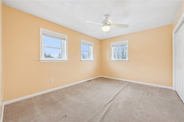 empty room featuring light carpet and ceiling fan