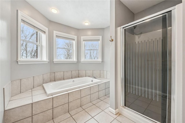 bathroom with a healthy amount of sunlight, separate shower and tub, and tile patterned flooring