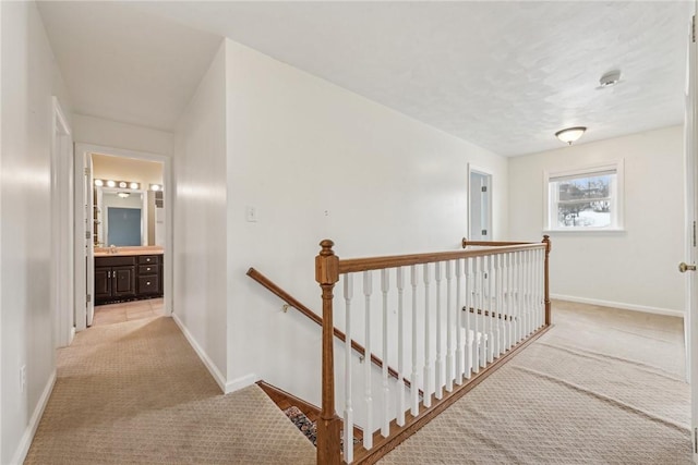 hallway featuring light carpet