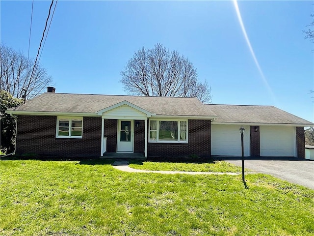 185 Holly Ln, Somerset Twp, PA 15501 - ranch-style home with a garage, brick siding, a front lawn, and driveway