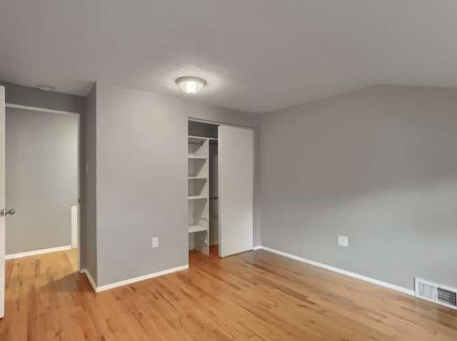 unfurnished bedroom featuring a closet and light wood-type flooring