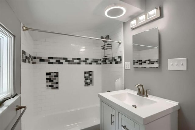 bathroom featuring vanity and tiled shower / bath combo