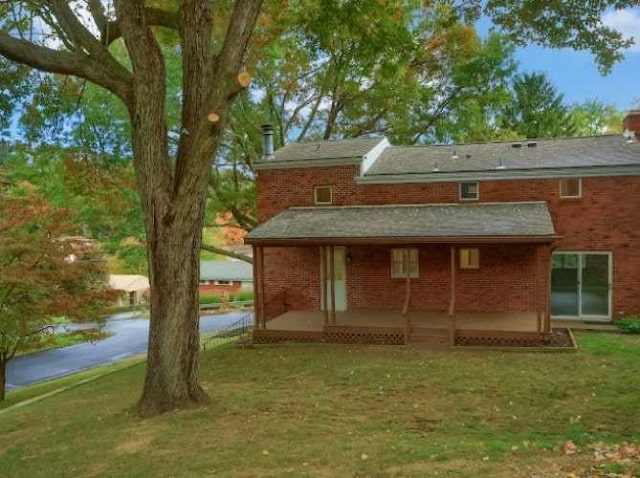 rear view of house with a lawn