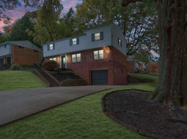 property exterior at dusk with a garage and a lawn