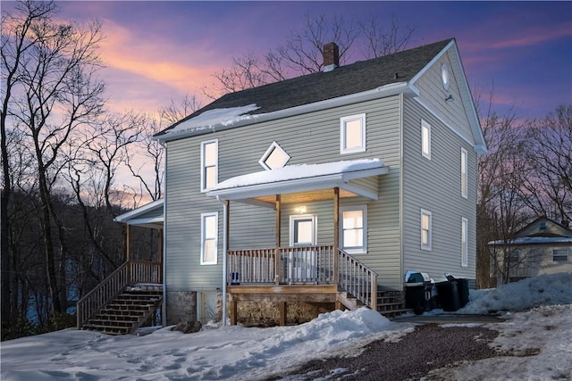 view of front property featuring covered porch