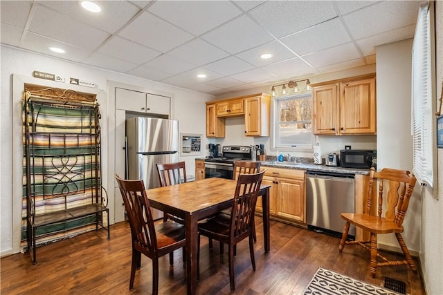 kitchen featuring dark hardwood / wood-style flooring, sink, stainless steel appliances, and a drop ceiling