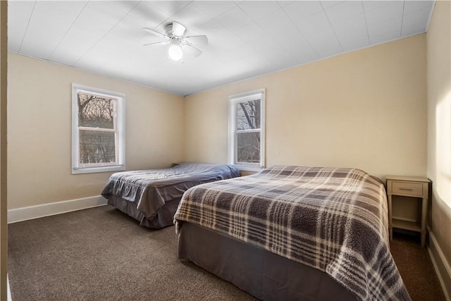 bedroom featuring ceiling fan and dark carpet