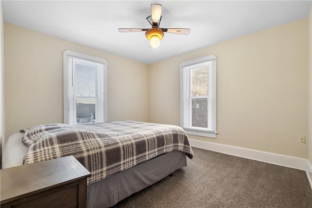 bedroom featuring multiple windows, ceiling fan, and dark colored carpet