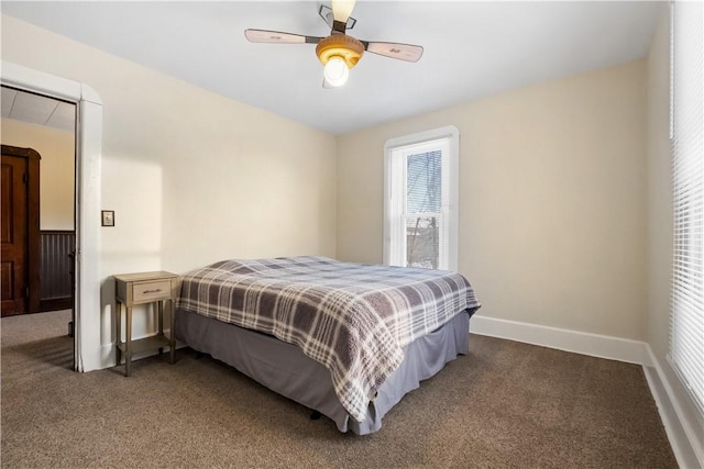 bedroom with ceiling fan and dark colored carpet