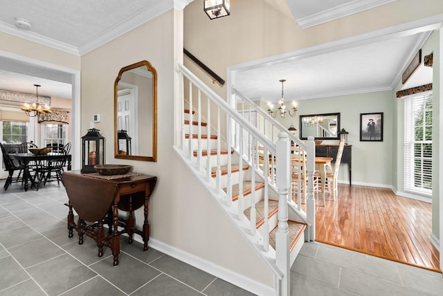 stairway with tile patterned flooring, a notable chandelier, and ornamental molding