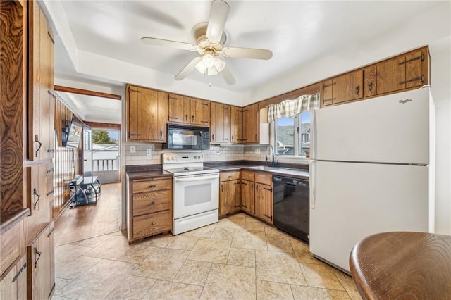 kitchen featuring sink, backsplash, plenty of natural light, and black appliances