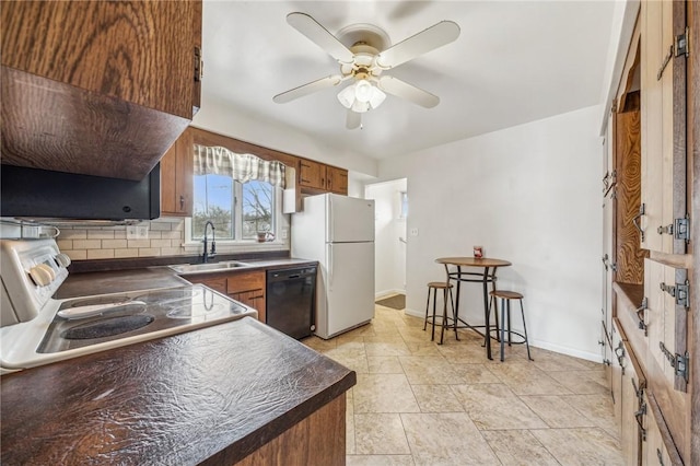 kitchen with sink, stove, black dishwasher, white refrigerator, and decorative backsplash