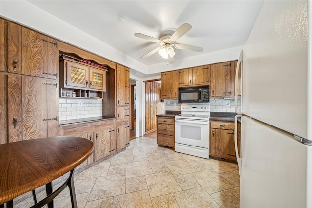 kitchen featuring tasteful backsplash, white appliances, and ceiling fan