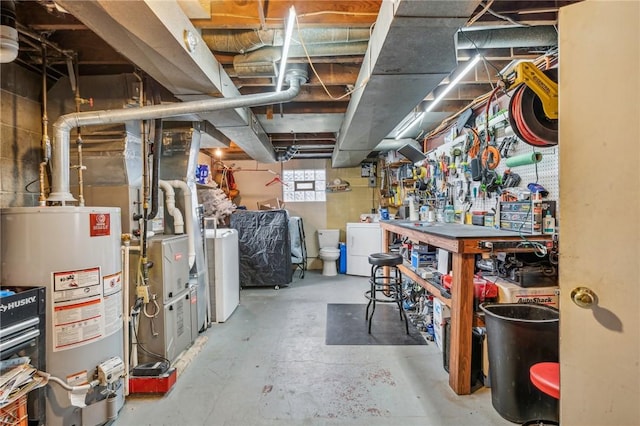 basement featuring gas water heater and washer / dryer