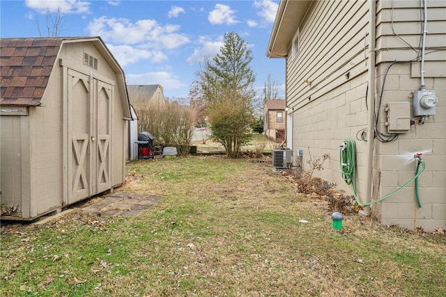 view of yard with a shed and central AC