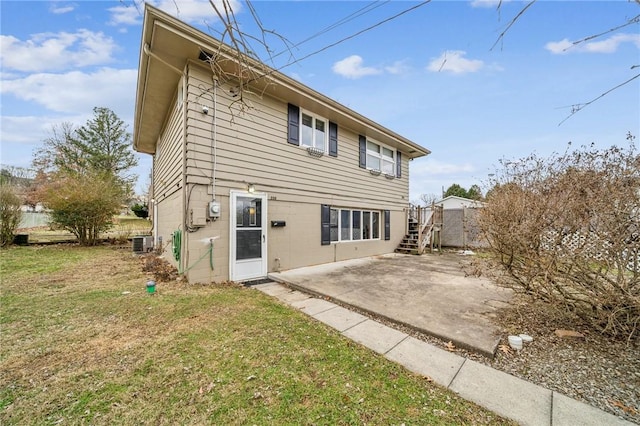 rear view of house featuring central AC unit, a lawn, and a patio