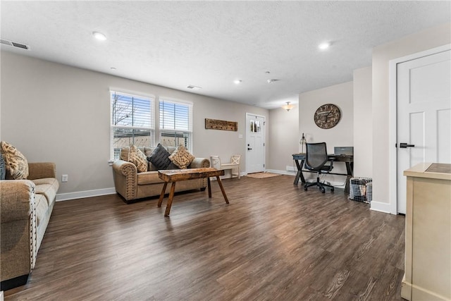 living room with dark hardwood / wood-style floors and a textured ceiling