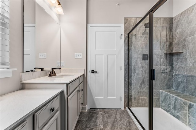 bathroom featuring vanity and an enclosed shower