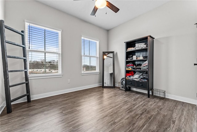 unfurnished bedroom featuring ceiling fan and dark hardwood / wood-style flooring