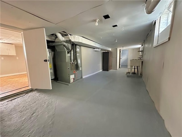 basement featuring heating unit and water heater