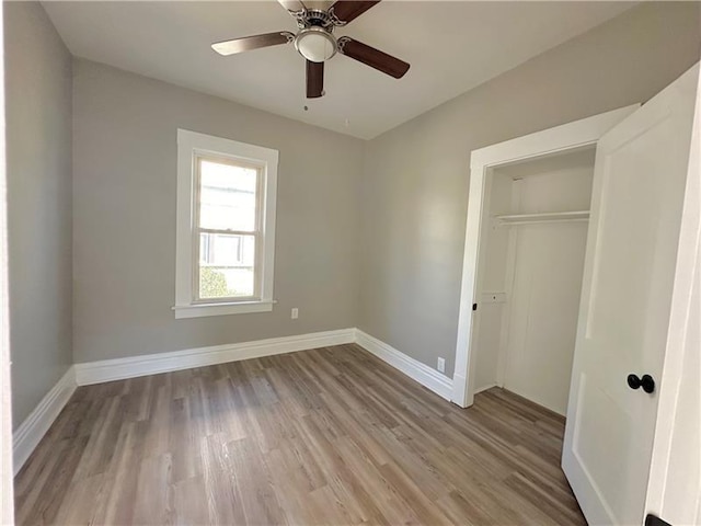 unfurnished bedroom with a closet, ceiling fan, and light hardwood / wood-style flooring