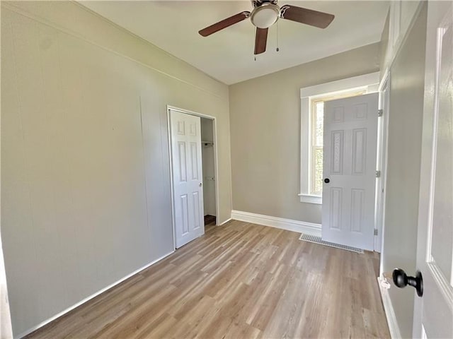 unfurnished room featuring ceiling fan and light wood-type flooring