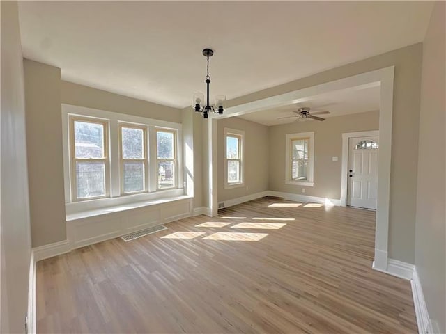 interior space with a chandelier and light hardwood / wood-style floors