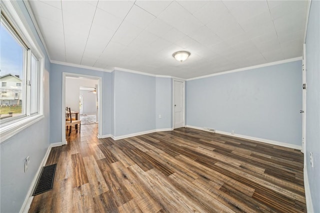 unfurnished room featuring wood-type flooring and crown molding