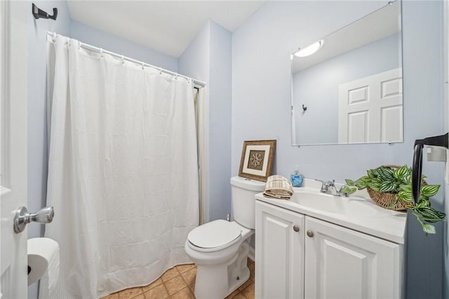 bathroom with tile patterned flooring, vanity, and toilet